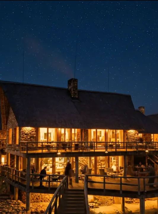 Edifício de telhado de colmo iluminado debaixo de um céu estrelado